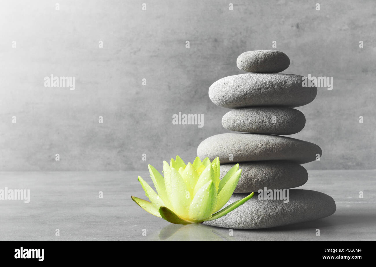 Stones balance and white flower lotus. Zen and spa concept. Stock Photo