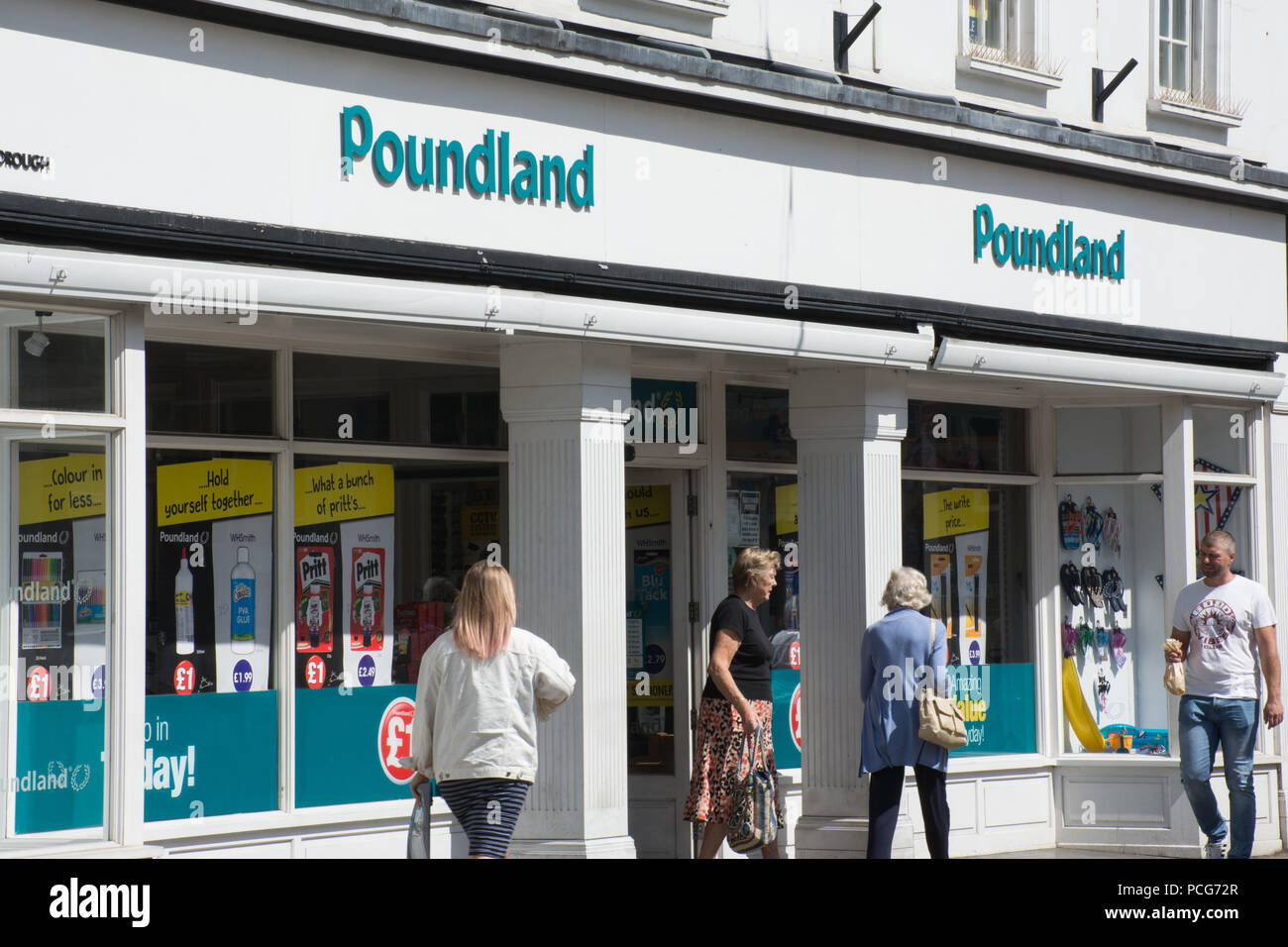 Poundland shop front with people walking past on the high street Stock Photo
