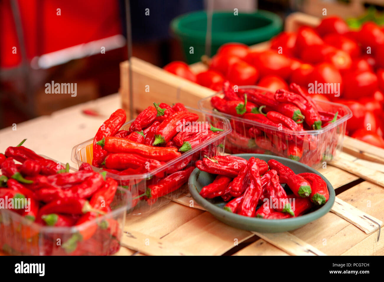 Trays of hot Red Chilli Peppers on Market Stall for sale Stock Photo