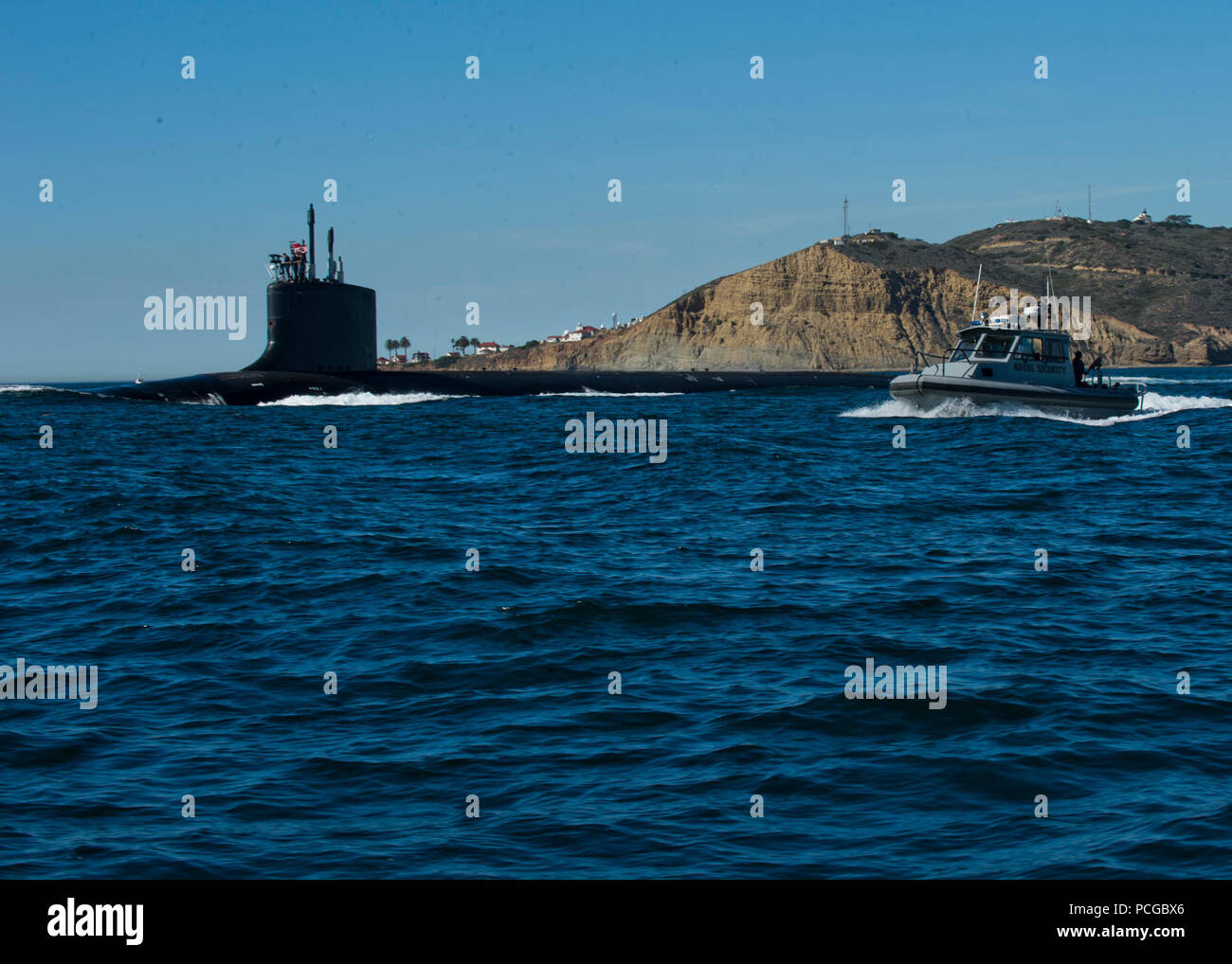 SAN DIEGO (Feb. 6, 2013) Sailors assigned to Commander Navy Region Southwest Harbor Patrol escort as Virgina-class fast-attack submarine out of San Diego Harbor during a high-value transit. Stock Photo