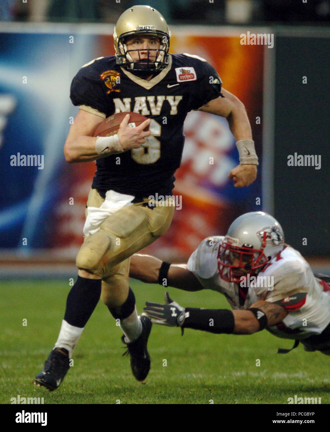 Francisco, Calif. (Dec. 29, 2004) U.S. Naval Academy Midshipman 1st Class Aaron Polanco runs for yardage in the 3rd quarter of play against the Lobos of New Mexico at the Emerald Bowl in San Francisco.  Polanco passed for 102 yards and a touchdown and rushed for 133 yards and three more scores for the Midshipmen (10-2)  The Senior quarterback was 3-of-6 passing with 26 rushes, also caught two passes for 23 yards. Navy triumphed over New Mexico 34-19 for their first bowl win since 1996 and first 10 game winning record in 99 years. U.S. Navy Stock Photo