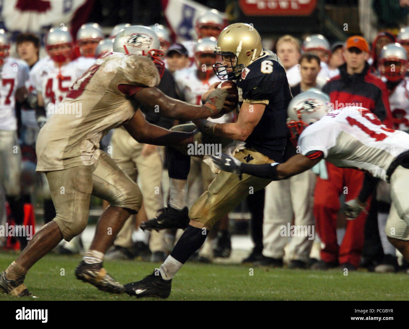 Francisco, Calif. (Dec. 29, 2004) U.S. Naval Academy Midshipman 1st Class Aaron Polanco catches a pass from slot back Frank Divis in the 4th quarter of play against the Lobos of New Mexico at the Emerald Bowl in San Francisco.  Polanco passed for 102 yards and a touchdown and rushed for 133 yards and three more scores for the Midshipmen (10-2)  The Senior quarterback was 3-of-6 passing with 26 rushes, also caught two passes for 23 yards. Navy triumphed over New Mexico 34-19 for their first bowl win since 1996 and first 10 game winning record in 99 years. U.S. Navy Stock Photo