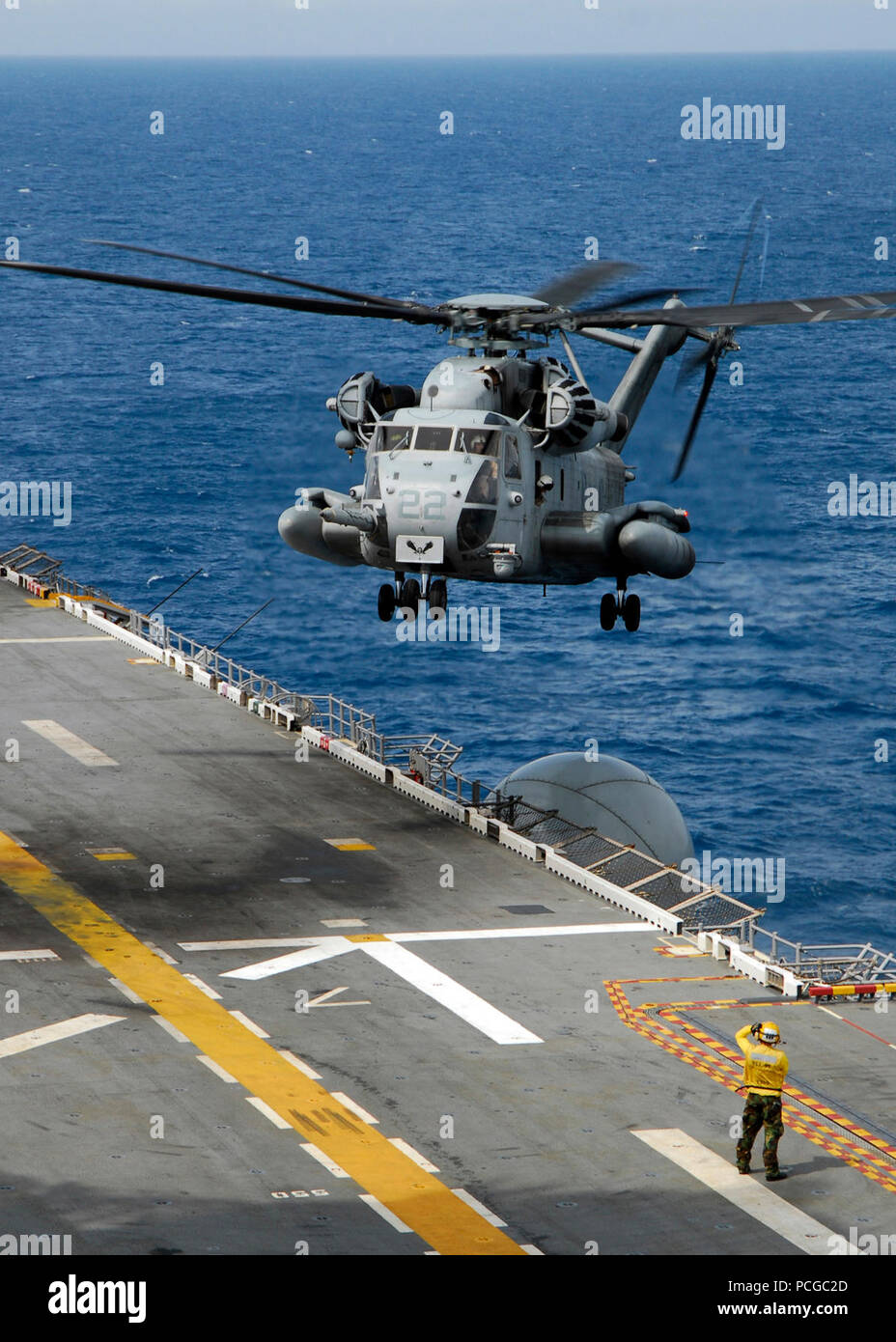 A CH-53E Super Stallion from Marine Medium Helicopter Squadron 264 lands on the flight deck of the multi-purpose amphibious assault ship USS Iwo Jima. Iwo Jima, the flagship of the Iwo Jima Expeditionary Strike Group, is on a scheduled deployment en route to the U.S. 5th and 6th Fleet areas of responsibility supporting maritime security operations. Stock Photo