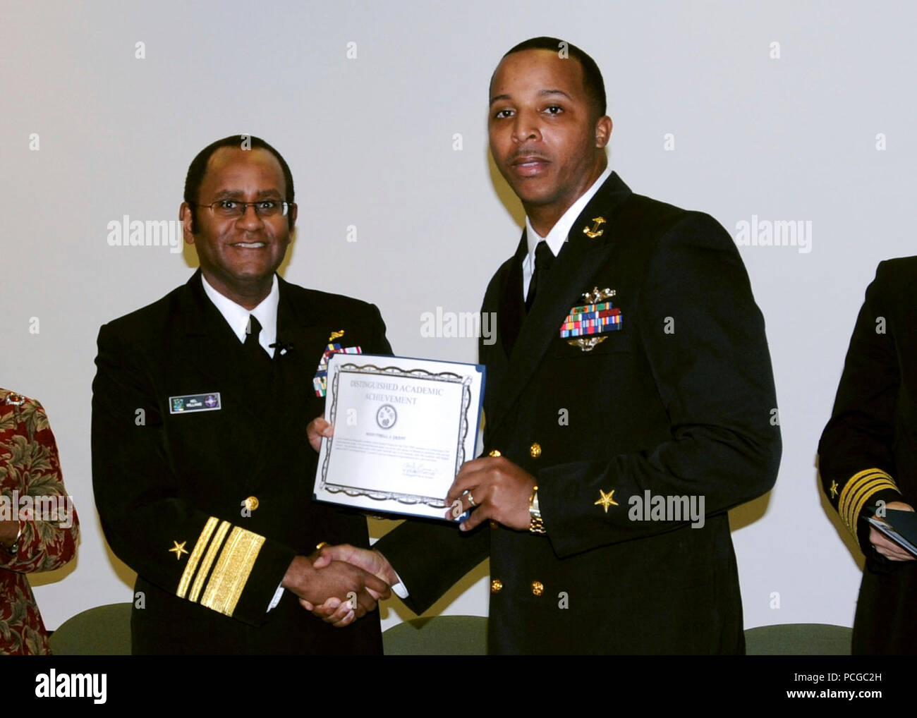.NORFOLK (Feb. 9, 2009) Officer Candidate Tyrell Grant receives the Distinguished Academic Award from Vice Adm. Mel Williams Jr., commander of U.S. 2nd Fleet during an awards ceremony in celebration of Black History Month. Grant, formerly an active-duty Electronics Technician 1st Class, received the award for having a grade point average of 3.81 for the Fall 2008 semester. Stock Photo