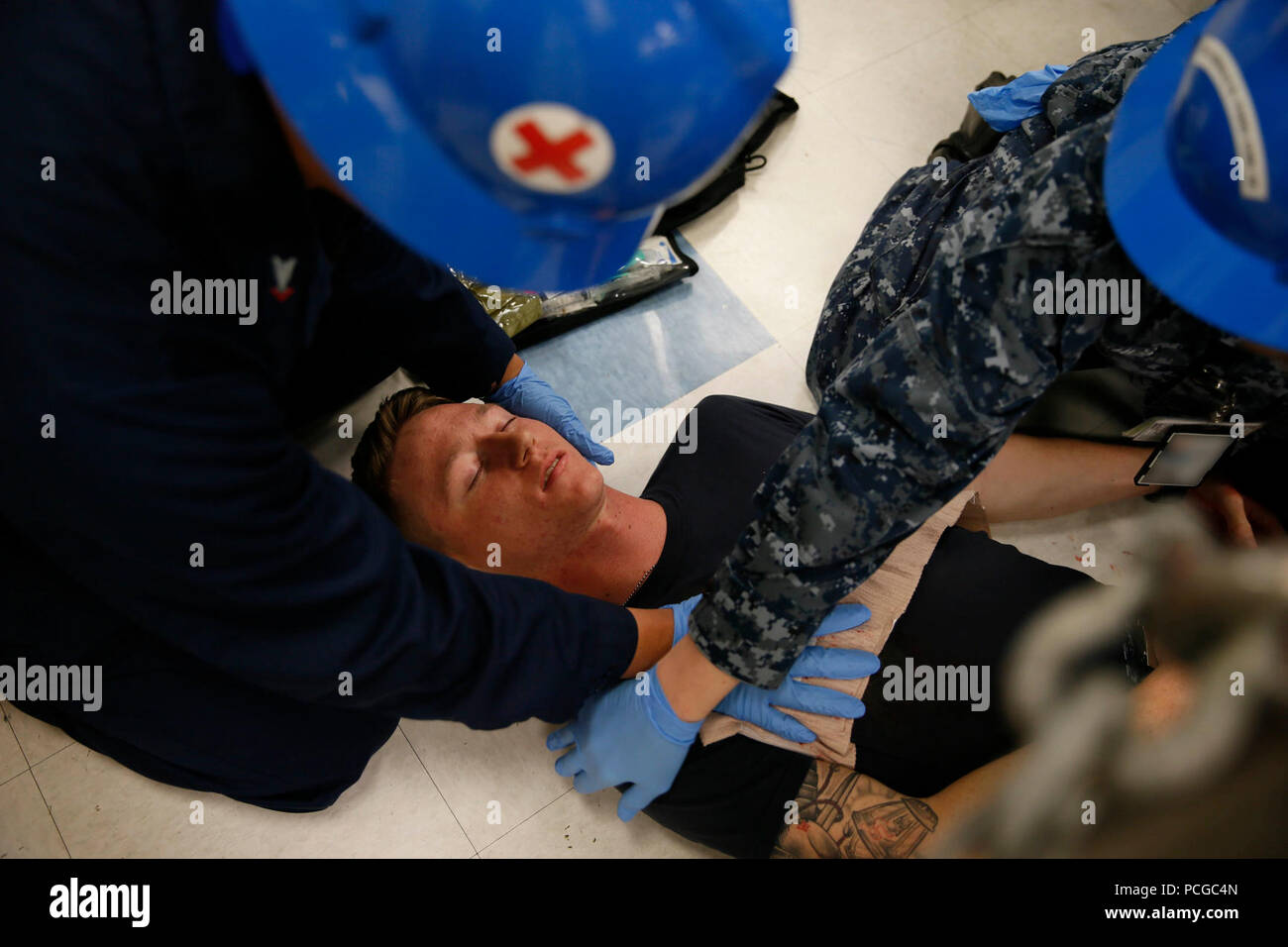NEWPORT NEWS, Va. (June 8, 2016) – Pre-Commissioning Unit Gerald R. Ford (CVN 78) Hospital Corpsman 3rd Class Briccio Rapido and Hospitalman Hayley Hughes provide medical assistance to a victim's gunshot wound during an active shooter drill in the ship's mess decks. Ford is the first of its class and is under construction at Huntington Ingalls Newport News Shipbuilding. Stock Photo