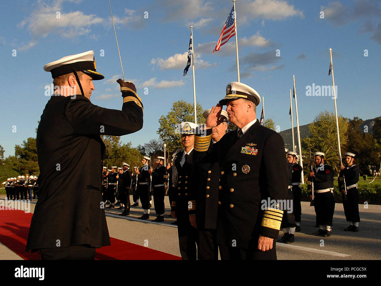 (Nov. 12, 2009) During a welcoming ceremony at the Hellenic Navy General Staff (HNGS) headquarters, Chief of Naval Operations (CNO) Adm. Gary Rouhgead, right, salutes the officer in charge at the completion of inspecting the troops with Chief of the HNGS, Vice Adm. Georgios Karamalikisas, as part of the official counterpart visit to the Hellenic Navy. Stock Photo