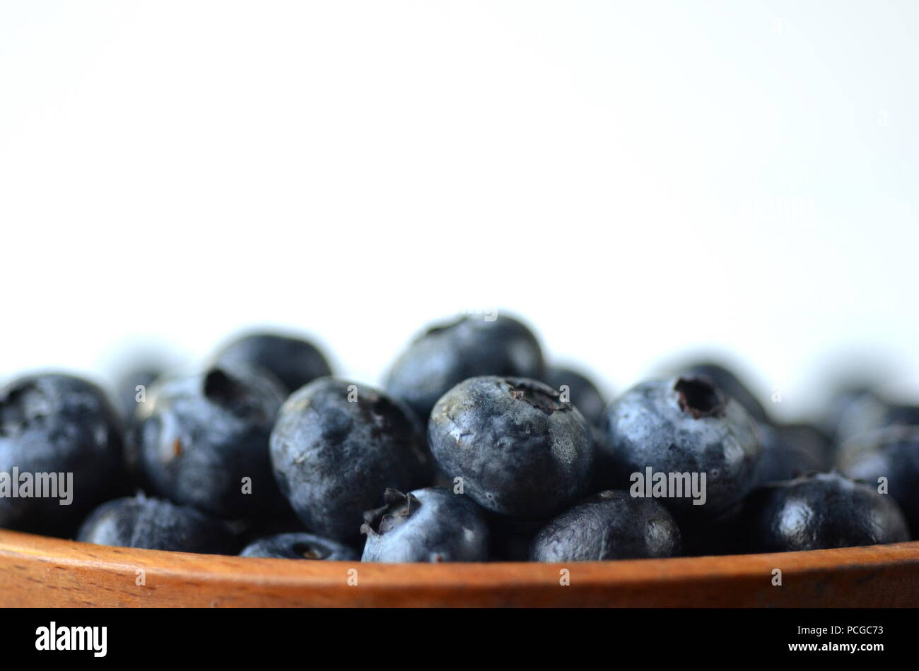 Detail of fresh summer fruit, berries. Direct front view of blueberries with copy space Stock