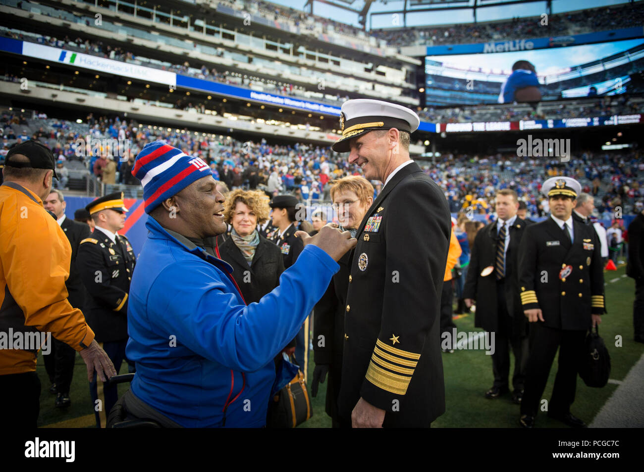 EAST RUTHERFORD, N.J. (Nov. 4, 2012) Chief of Naval Operations (CNO) Adm. Jonathan Greenert talks with Army Col. Gregory D. Gadson, base commander of Fort Belvoir, Va., and a double amputee who stared in the movie 'Battleship,' at a NFL military appreciation game at Metlife Stadium. The NFL chose November in conjunction with Veteran's Day to honor the military with their 'Salute to Service' campaign, highlighting service members' contribution to our nation. Stock Photo