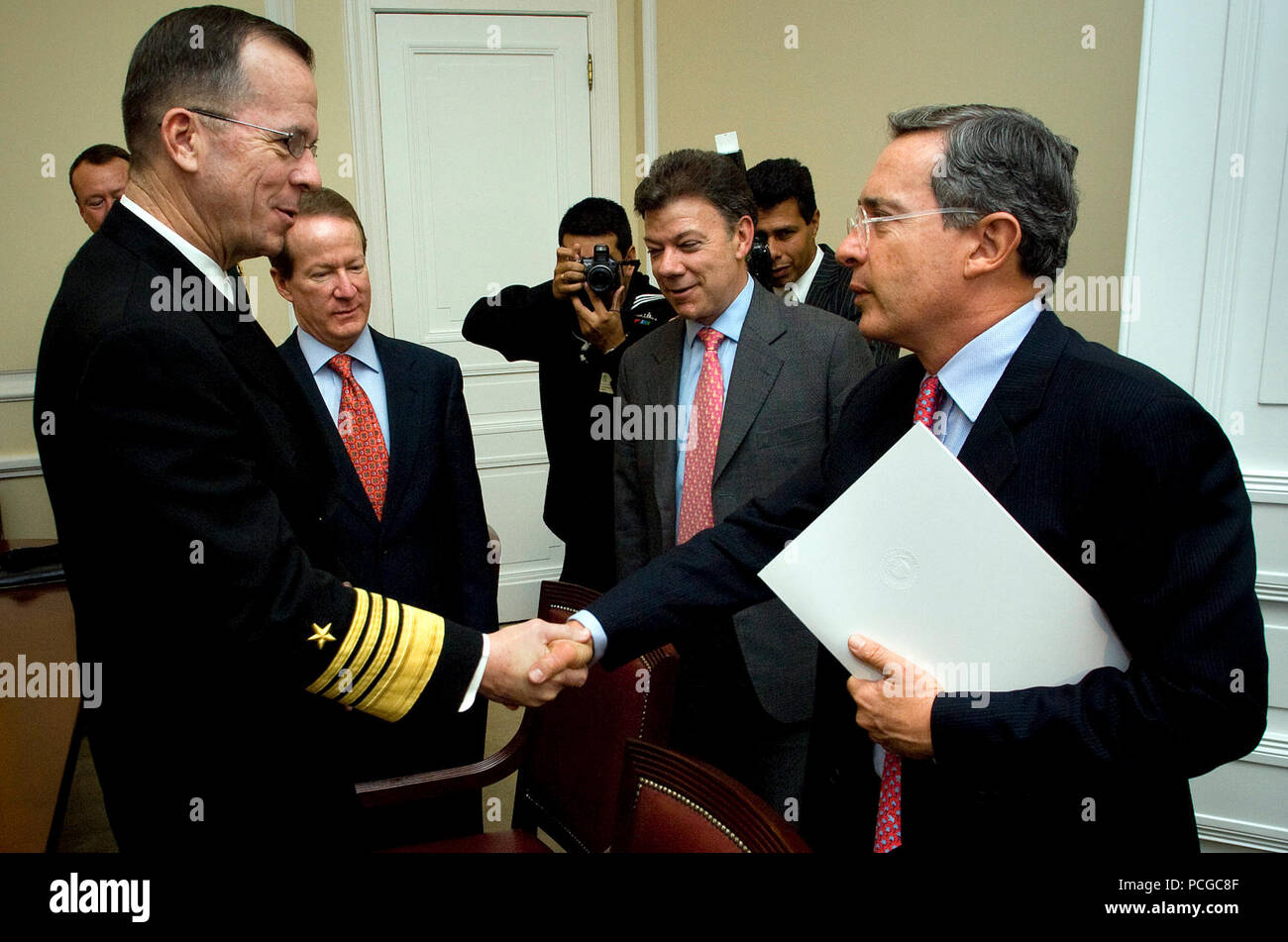 Columbia (Jan. 17, 2008) - U.S. Navy Adm. Mike Mullen, chairman of the Joint Chiefs of Staff along with the honorable William Brownfield, U.S. Ambassador to Columbia and Dr. Juan Manuel Santos, Columbian minister of defense greet Columbian President Dr. Alvaro Uribe Velez at the presidential palace in Bogota, Columbia, Jan 17, 2007. Mullen is wrapping up a five-day trip to the U.S. Southern Command area of operations with a final stop in San Salvador, El Salvador. Stock Photo