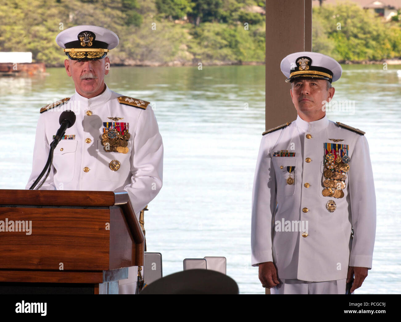PEARL HARBOR (May 27, 2015) Adm. Scott H. Swift reads his orders as he assumes command of U.S. Pacific Fleet from Adm. Harry B. Harris Jr., right, during the joint U.S. Pacific Command and U.S. Pacific Fleet change of command ceremony at Joint Base Pearl Harbor-Hickam.  Swift relieved Harris as the U.S. Pacific Fleet commander and Harris assumed command of U.S. Pacific Command from Adm. Samuel J. Locklear III. Stock Photo