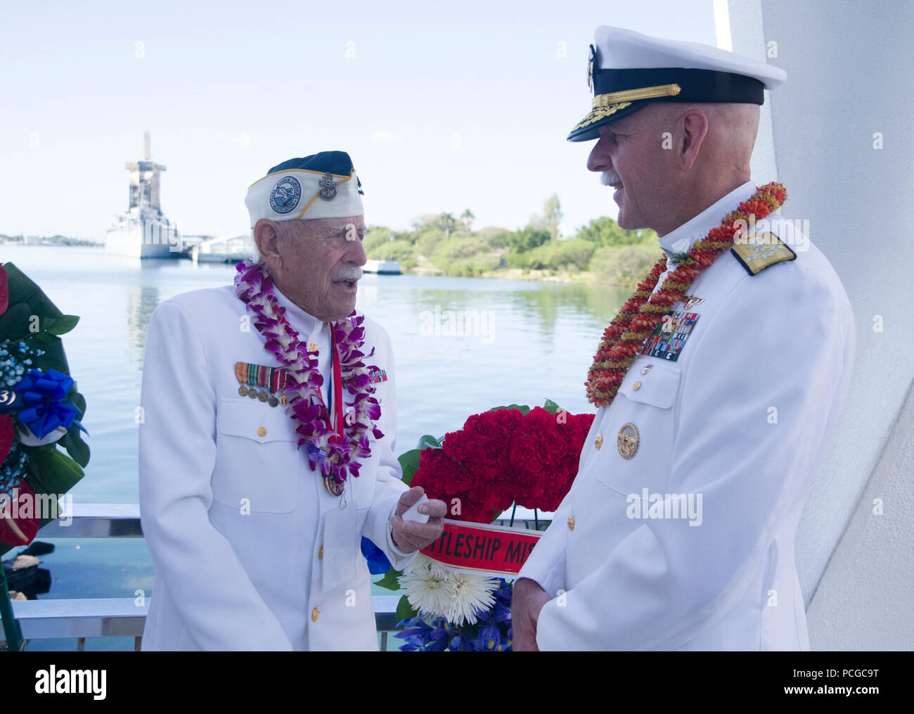 PEARL HARBOR (Dec. 7, 2017) Adm. Scott Swift, commander, U.S. Pacific Fleet, right, and Pearl Harbor survivor Delton 'Wally' Walling, left,  talk following the conclusion of the floral tribute aboard the USS Arizona Memorial during the 76th Anniversary of the attacks on Pearl Harbor and Oahu at Joint Base Pearl Harbor-Hickam. The 76th commemoration, co-hosted by the U.S. Military, the National Park Service and the State of Hawaii, provided veterans, family members, service members and the community a chance to honor the sacrifices made by those who were present Dec. 7, 1941, as well as through Stock Photo