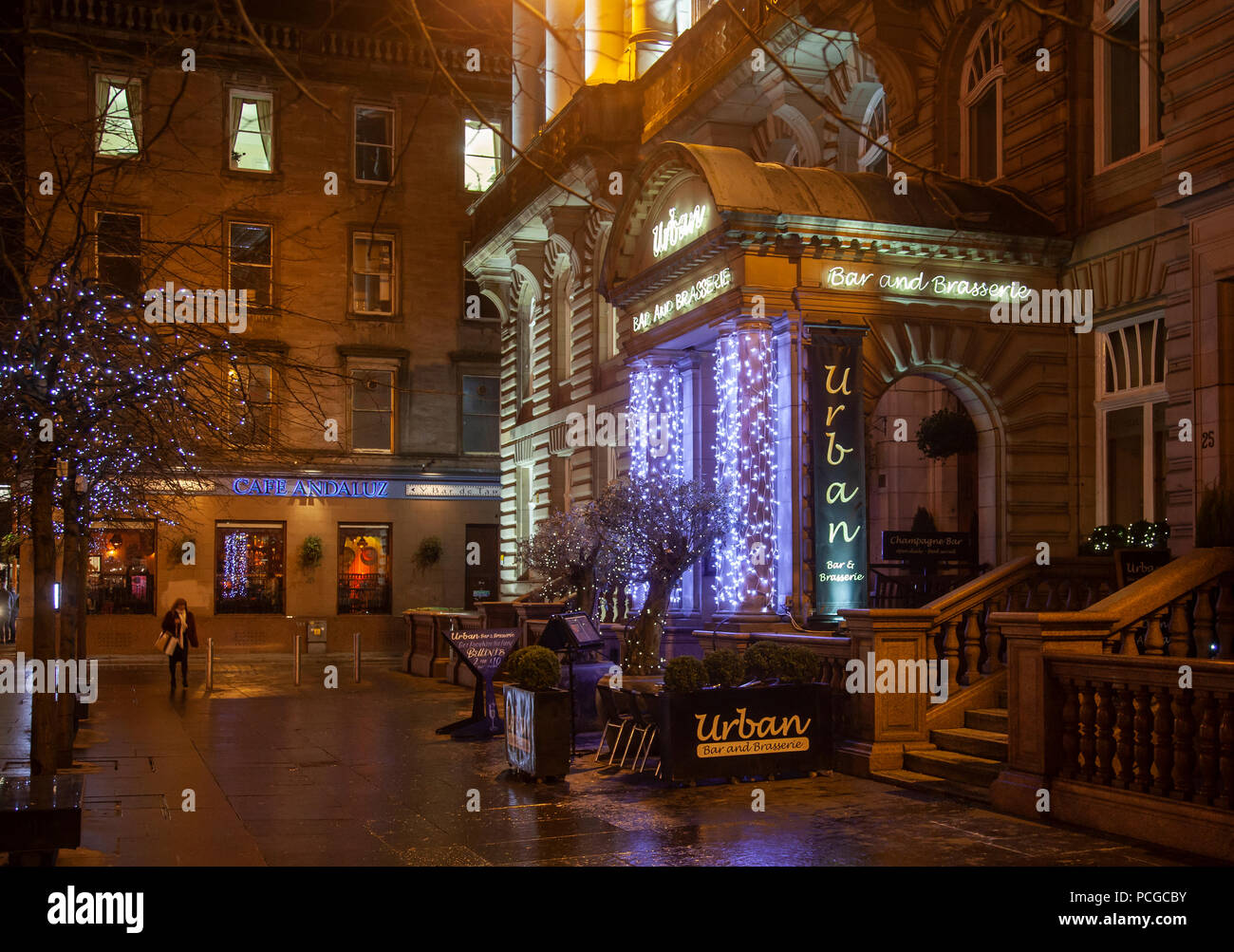 Exterior of Urban, a bar and brasserie in central Glasgow with fairy lights on a wet, winter evening. Cafe Andaluz tapas bar. Scotland, UK Stock Photo