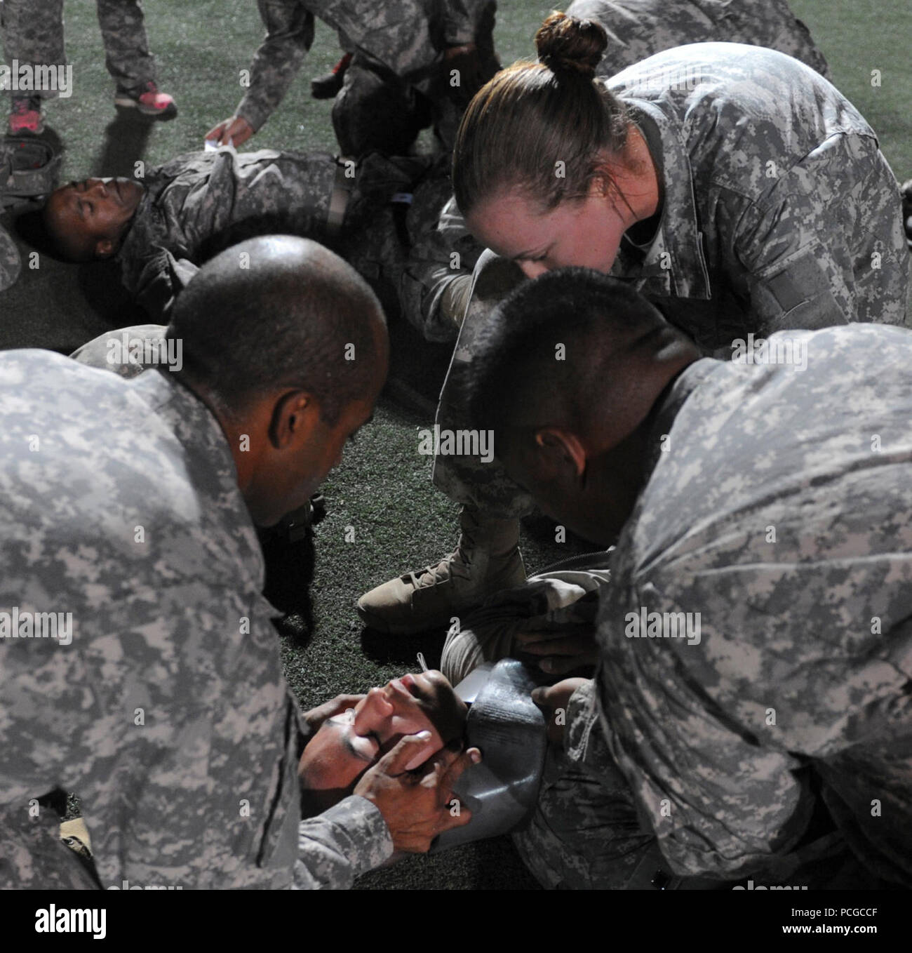 – Medics from 1st Combined Arms Battalion, 63rd Armor Regiment, 2nd Armored Brigade Combat Team, 1st Infantry Division, conduct advanced trauma lanes training on Turf Field at Camp Lemonnier, Djibouti, Aug. 31, 2013. Trauma lanes is advanced medical training that prepares the medics to respond to battlefield injuries. This ensures military members assigned to Combined Joint Task Force-Horn of Africa are ready at a moment’s notice to deploy supporting military-to-military engagements throughout East Africa. Stock Photo