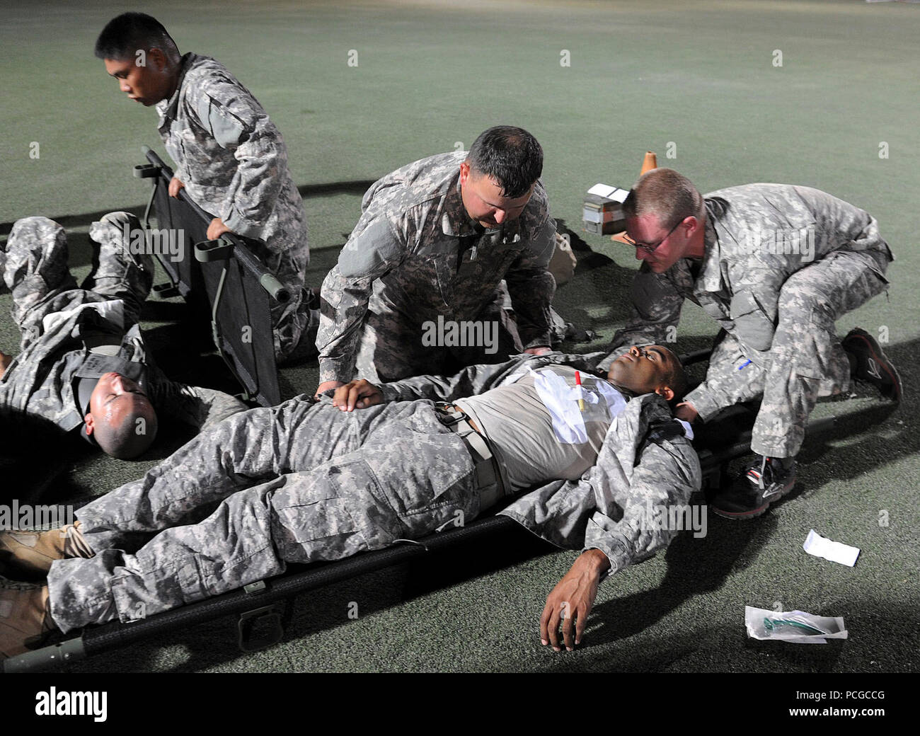 Medics from 1st Combined Arms Battalion, 63rd Armor Regiment, 2nd Armored Brigade Combat Team, 1st Infantry Division, conduct advanced trauma lanes training on Turf Field at Camp Lemonnier, Djibouti, Aug. 31, 2013. Trauma lanes is advanced medical training that prepares the medics to respond to battlefield injuries. This ensures military members assigned to Combined Joint Task Force-Horn of Africa are ready at a moment's notice to deploy supporting military-to-military engagements throughout East Africa. Stock Photo