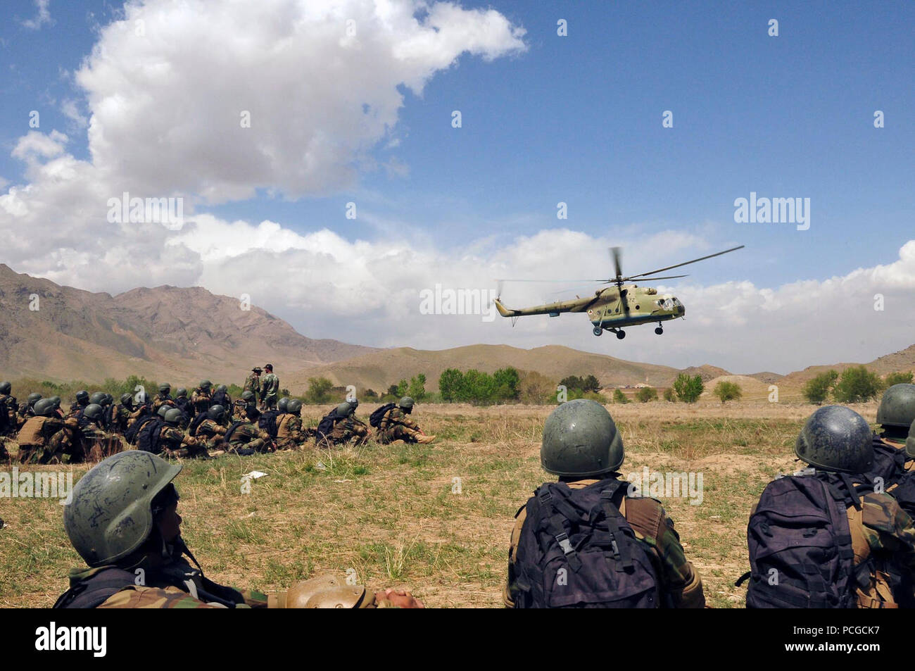 KABUL, Afghanistan - Afghan commandos from the Sixth Commando Kandak wait for a Mi-17 helicopter to land as they practice infiltration techniques using the Afghan National Army Air Corps Mi-17Õs on April 1, 2010 at Camp Morehead in the outer regions of Kabul. The training was in preparation for future air assault missions needed in order to disrupt insurgent activity and bring stability to the population and the region. (US Navy Stock Photo