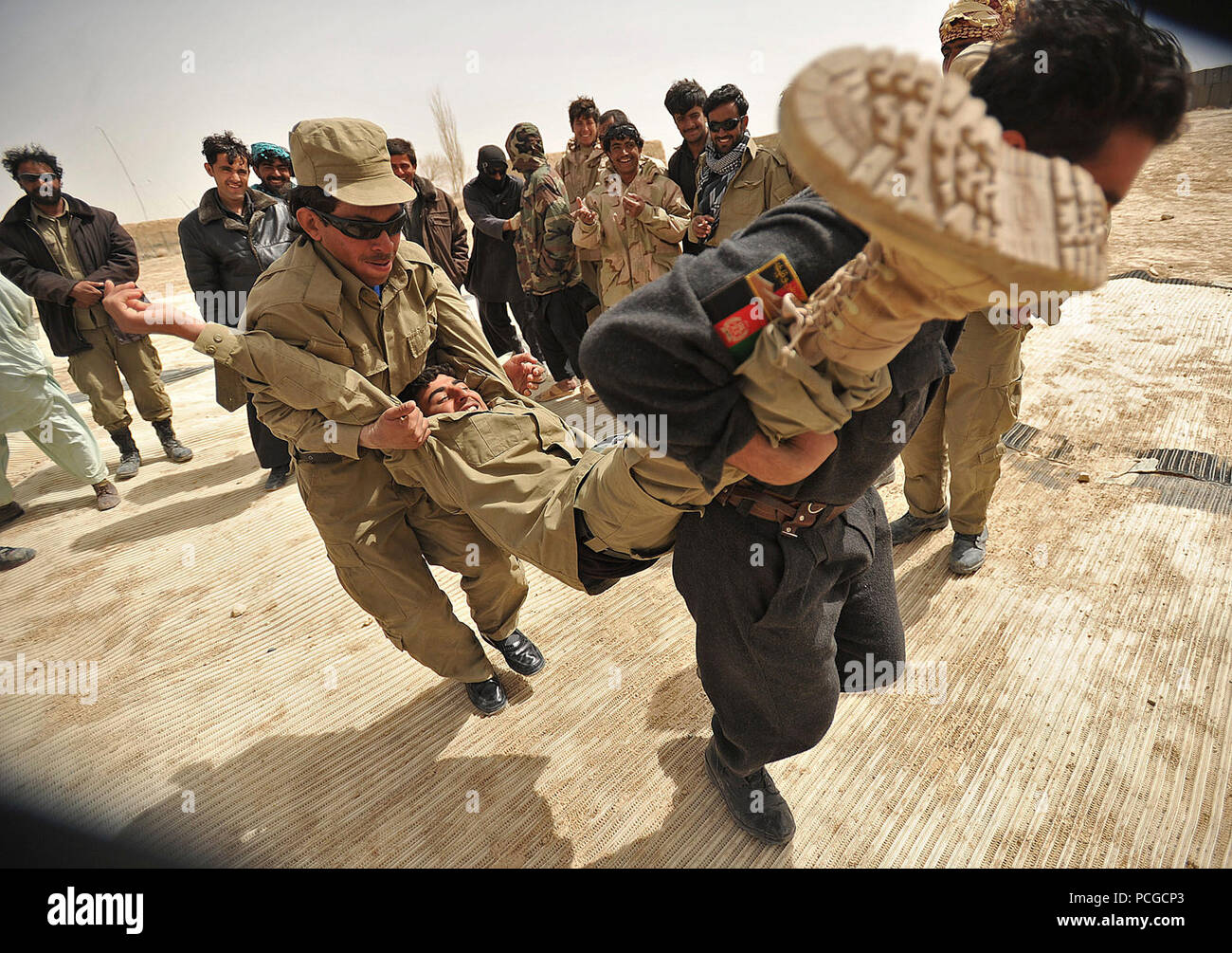 Afghan Local Police recruits practice different ways to extract a wounded team member during a combat medical class in Nawbahar district, Zabul province, Afghanistan, March 18.  The class is part of a three-week course that teaches ALP candidates basic policing procedures, weapons handling and other skills necessary to protect and defend Afghan citizens. Stock Photo