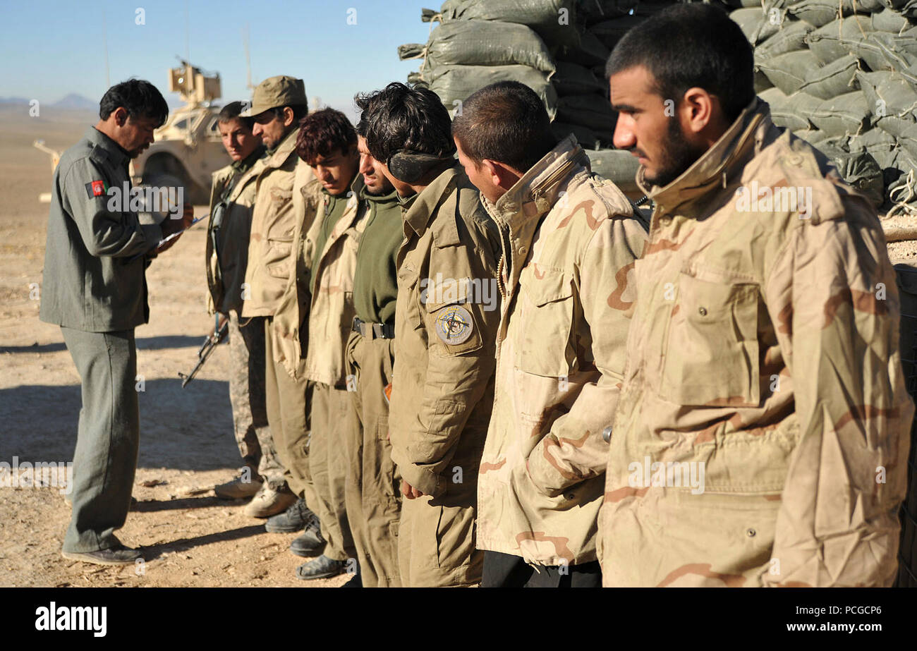 Afghan Local Police line up to receive their month's pay at the Pinzo checkpoint in Nawbahar district, Zabul province, Afghanistan, Jan. 12. The ALP is a defensive, community-oriented force that brings security and stability to rural areas of Afghanistan. Stock Photo