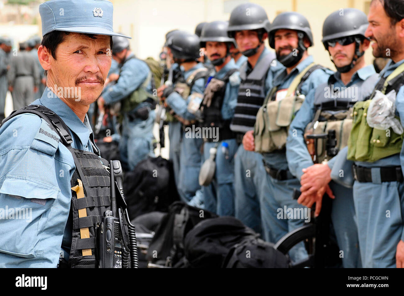 An Afghan national civil order police non-commissioned officer, left,  prepares members of the elite force for a personnel and gear inspection.  Brig. Gen. Anne Macdonald, Assistant Commanding General-Police Development,  NATO Training Mission ?