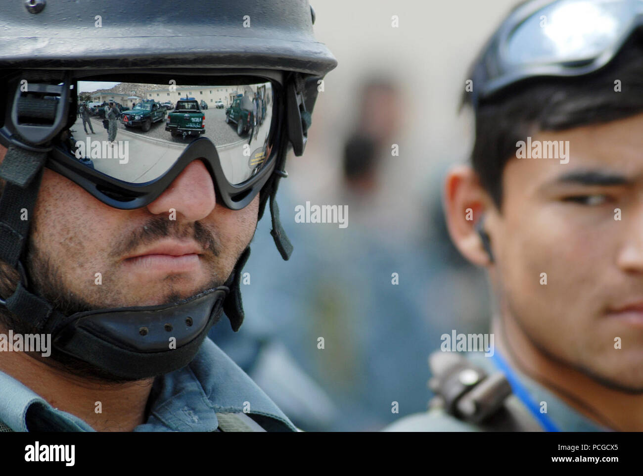 KABUL, Afghanistan (April 18, 2010) – A member of the Afghan National Civil Order Police (ANCOP), reflects his surroundings while waiting for the next training evolution at a Kabul facility.  The police officers registered and received briefings and training as they prepare for operations in Afghanistan. (US Navy Stock Photo