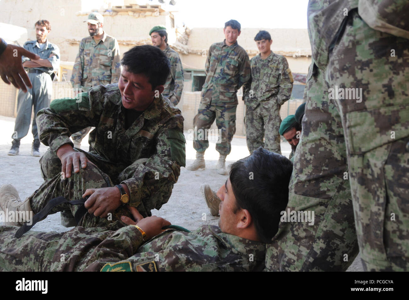 Afghan National Army soldiers practice applying combat tourniquets, June 9. This instruction also including direct pressure dressings and practical application. Stock Photo