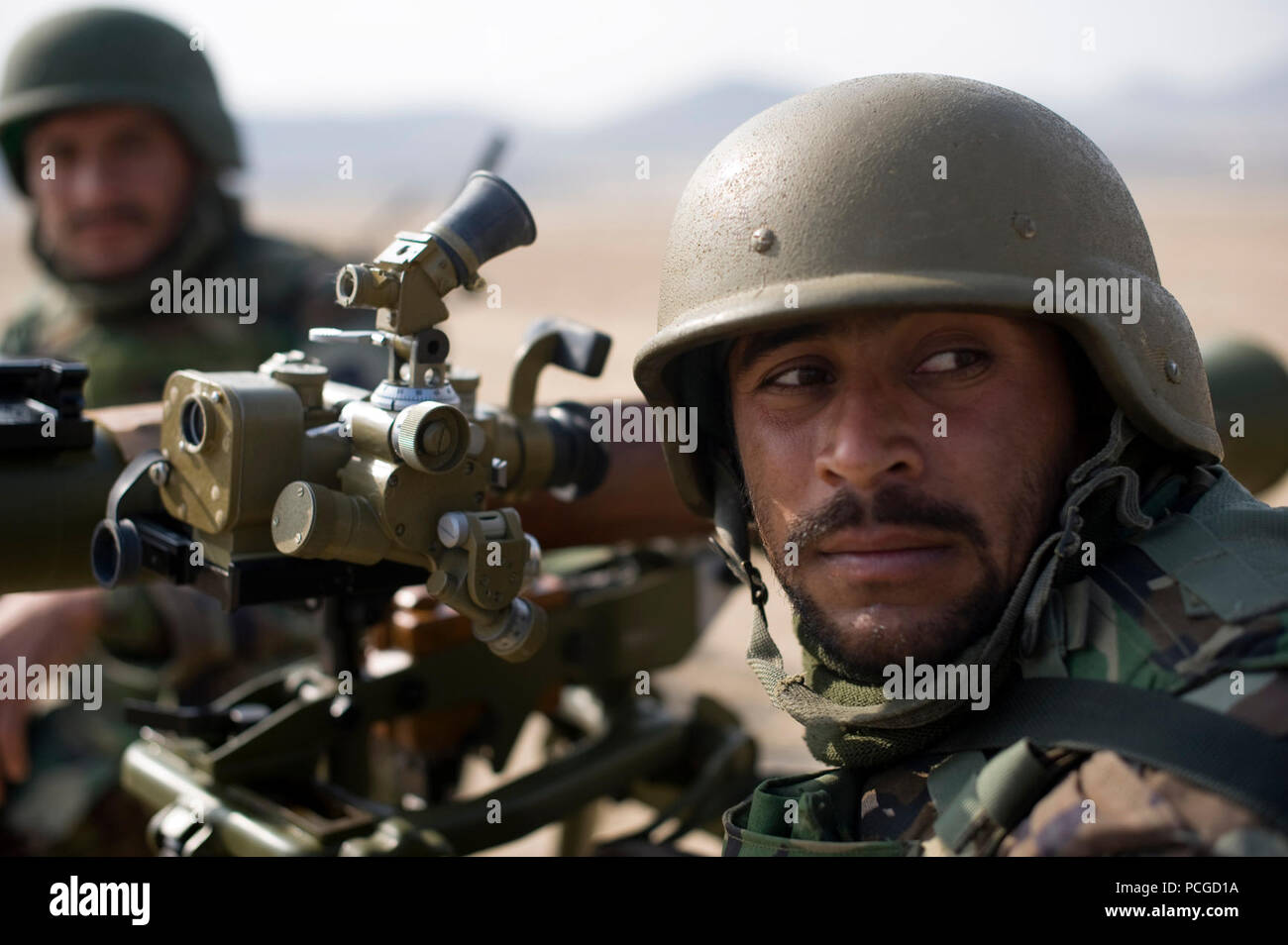 An Afghan National Army soldier sights in a SPG9 anti-tank weapon during weapons training at the Kabul Military Training Center, Jan. 30, in Kabul, Afghanistan. NTMA advisers provide guidance to Afghan National Army instructors who are charged with conducting the bulk of training for ANA recruits. Stock Photo