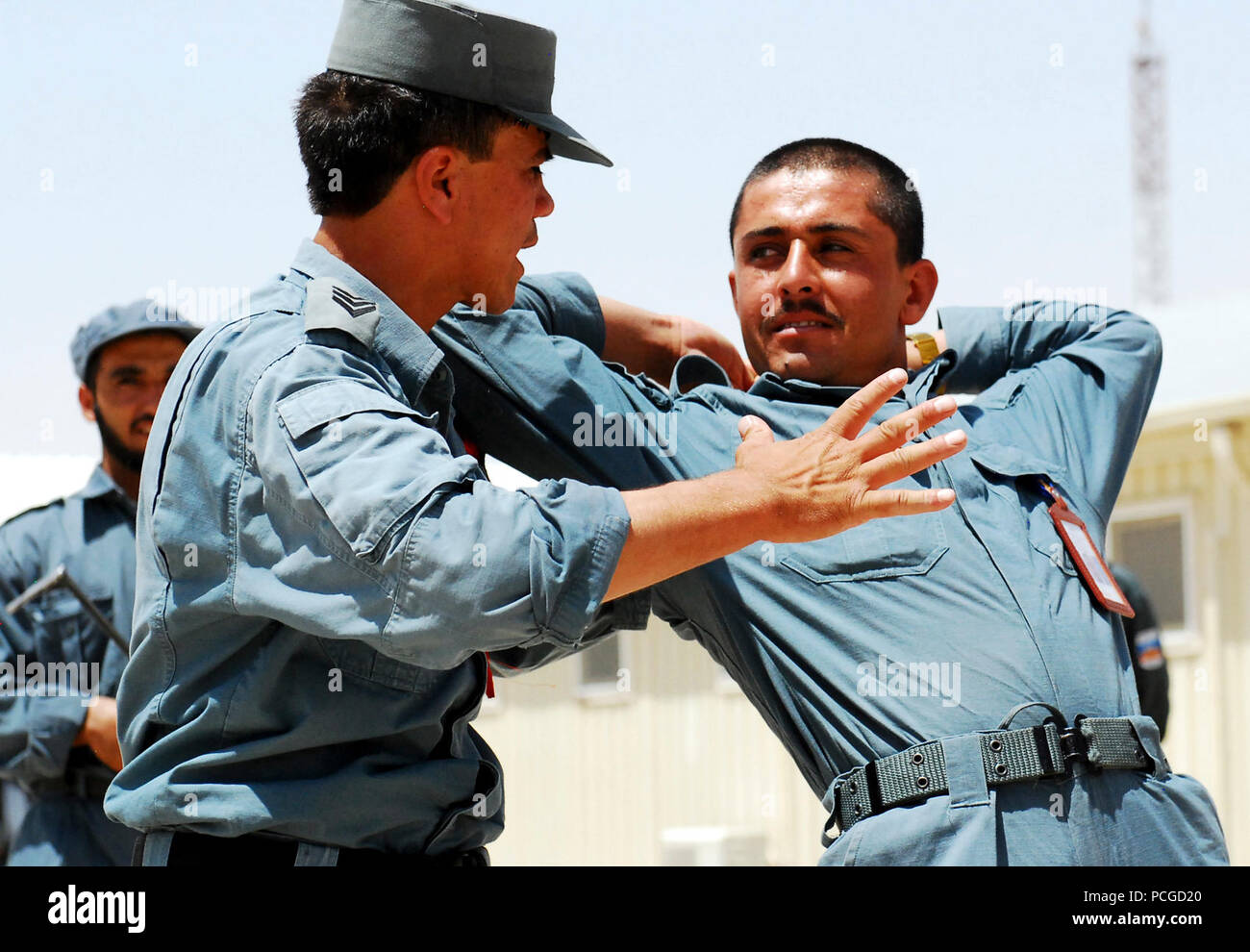 Afghanistan (July 19, 2010) – An Afghan National Police (ANP) instructor at Recruit Training Center-Kandahar (RTC-K) demonstrates a suspect apprehension and restraint technique. RTC-K has trained more than 17,747 Afghan volunteers to join the ranks of the ANP since its inception in 2004. U.S. Navy Stock Photo