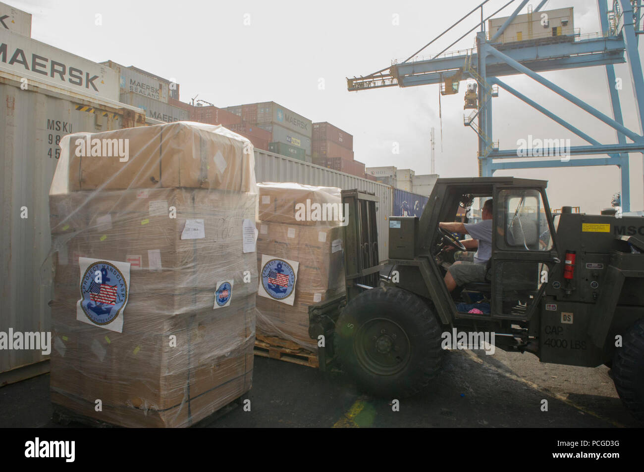 Jack Karg, a civil service mariner, unloads goodwill materials from the joint high speed vessel USNS Spearhead (JHSV 1) in support of Project Handclasp in Lagos, Nigeria, April 15, 2014. Project Handclasp is an official U.S. Navy program that accepts and transports educational, humanitarian and goodwill materials overseas on a space-available basis aboard Navy ships. The Spearhead was in Nigeria supporting Africa Partnership Station (APS) 2014. APS is an international security cooperation initiative facilitated by Commander, U.S. Naval Forces Europe-Africa aimed at strengthening global maritim Stock Photo