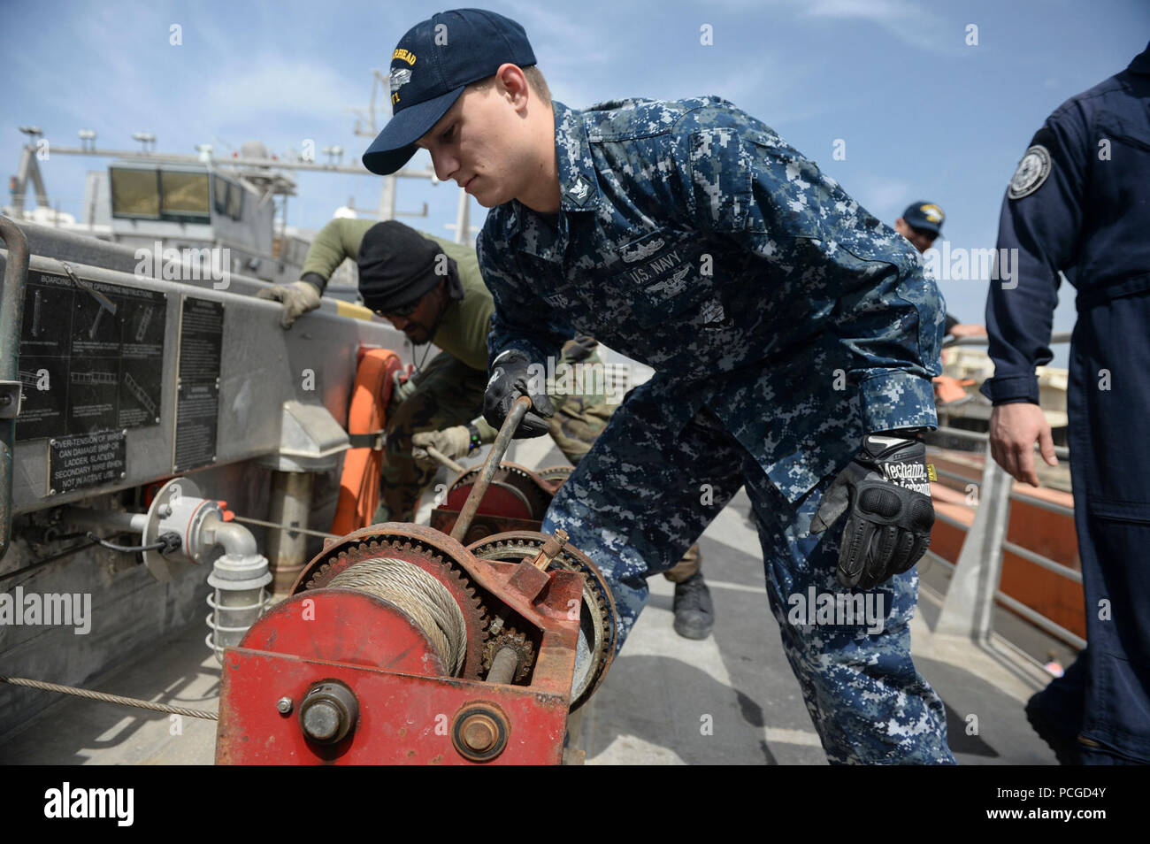Operations Specialist 2nd Class Joshua Watts lowers the brow of the Military Sealift Command’s joint high-speed vessel USNS Spearhead (JHSV 1) as the ship pulls in to Dakar, Senegal, Jan. 21, 2015. Spearhead is on a scheduled deployment to the U.S. 6th Fleet area of operations in support of the international collaborative capacity-building program Africa Partnership Station. Stock Photo