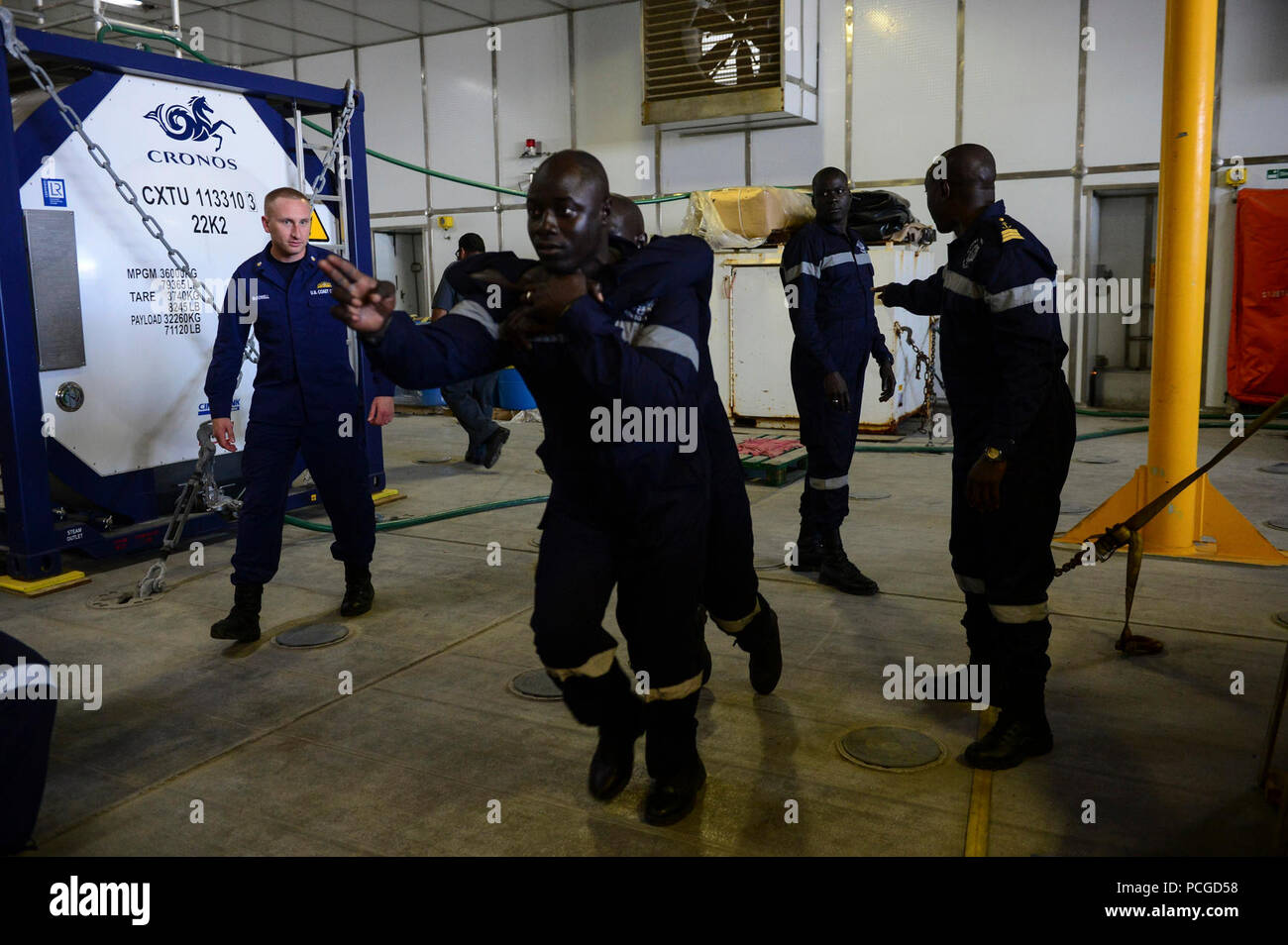U.S. Coast Guardsmen, assigned to Law Enforcement Detachment 407, and Senegalese military personnel conduct tactical casualty evacuation training aboard the Military Sealift Command’s joint high-speed vessel USNS Spearhead (JHSV 1) Jan 26, 2015. Spearhead is on a scheduled deployment to the U.S. 6th Fleet area of operations in support of the international collaborative capacity-building program Africa Partnership Station. Stock Photo
