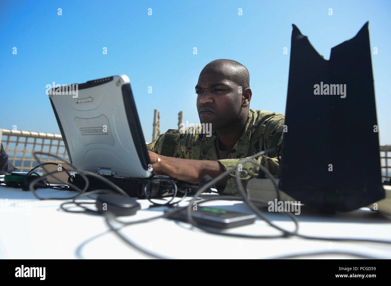 Chief Operations Specialist Dwayne Brown, from Brooklyn, N.Y., conducts unmanned aerial vehicle operations aboard the Military Sealift Command’s joint high-speed vessel USNS Spearhead (JHSV 1) Jan 26, 2015. Spearhead is on a scheduled deployment to the U.S. 6th Fleet area of operations in support of the international collaborative capacity-building program Africa Partnership Station. Stock Photo