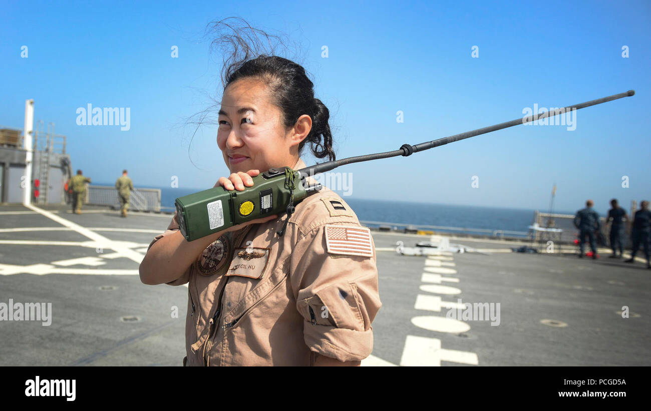 Lt. Cecilia Hu, from Los Angeles, coordinates a fly-over with the crew of a P-3 Orion aircraft, while aboard the Military Sealift Command’s joint high-speed vessel USNS Spearhead (JHSV 1) Jan 26, 2015. Spearhead is on a scheduled deployment to the U.S. 6th Fleet area of operations in support of the international collaborative capacity-building program Africa Partnership Station. Stock Photo