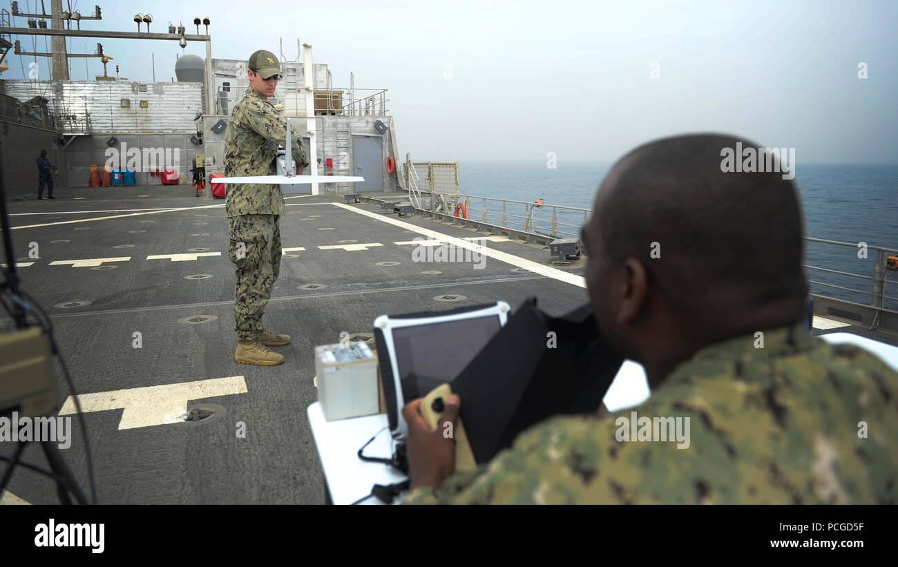 Information Technology Specialist 2nd Class Joshua Lesperance, left and Operations Specialist Chief Dwayne Brown conduct final checks before launching the Puma unmanned aerial vehicle during maritime law enforcement operations aboard the USNS Spearhead (JHSV 1), Jan. 29, 2015. Spearhead is on a scheduled deployment to the U.S. 6th Fleet area of operations in support of the international collaborative capacity-building program Africa Partnership Station. Stock Photo