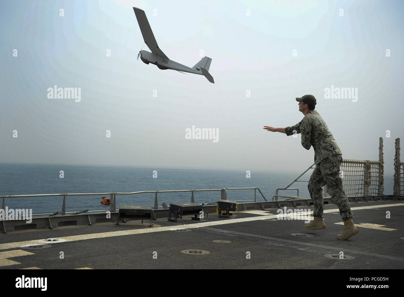 Information Technology Specialist 2nd Class Joshua Lesperance launches a Puma unmanned aerial vehicle during maritime law enforcement operations aboard the USNS Spearhead (JHSV 1), Jan. 29, 2015. Spearhead is on a scheduled deployment to the U.S. 6th Fleet area of operations in support of the international collaborative capacity-building program Africa Partnership Station. Stock Photo
