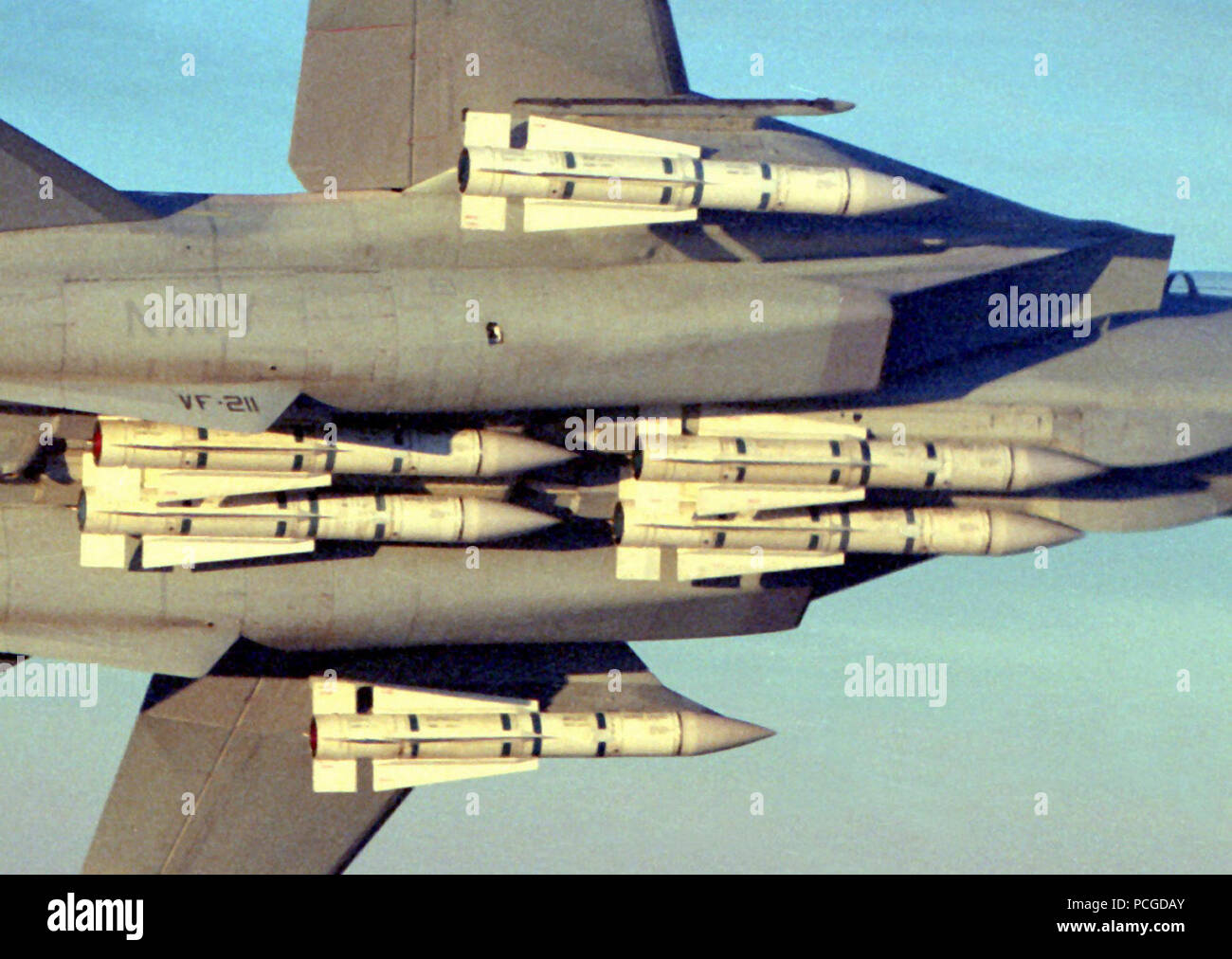 A Fighter Squadron 211 (VF-211) F-14A Tomcat aircraft banks into a turn ...