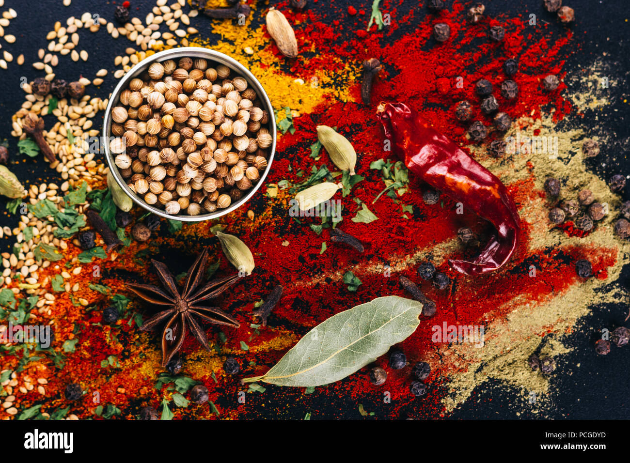 Disaster of spices and condiments for cooking, on a dark table, restaurant concept Stock Photo