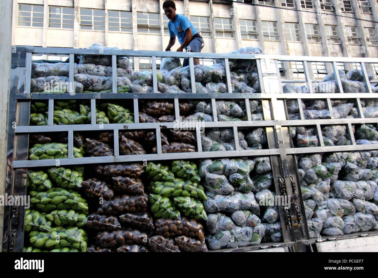 A vegetables vendor arranges their products along the street of Divisoria Market in Manila City on August 1, 2018. Divisoria Market is the Mother Market of all public market in Metro Manila which all products can be sold from dry products to wet market and even various types of appliances. Stock Photo