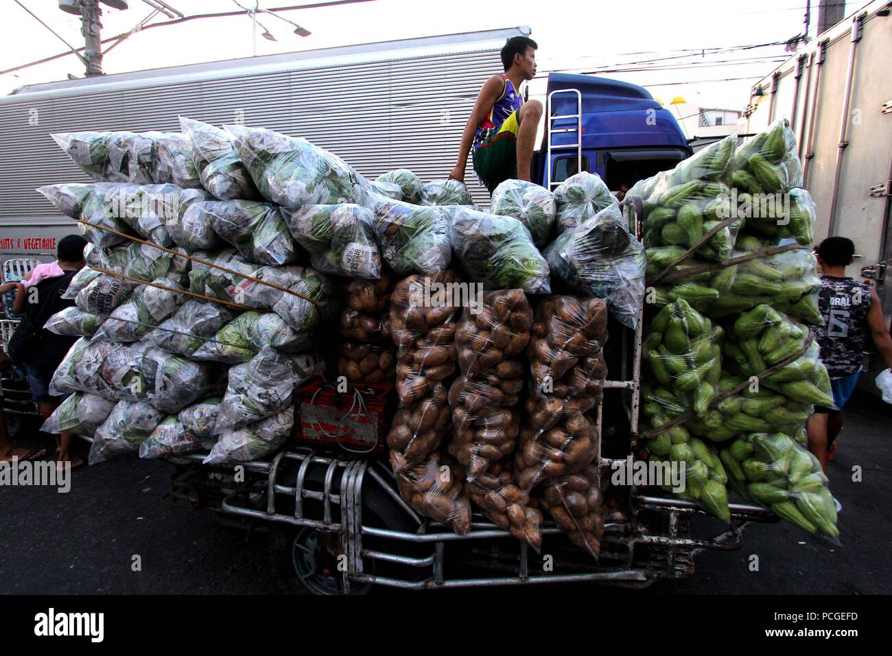 Load of root crops transported using modified tricycles along the street of Divisoria Market in Manila City on August 1, 2018. Divisoria Market is the Mother Market of all public market in Metro Manila which all products can be sold from dry products to wet market and even various types of appliances. Stock Photo