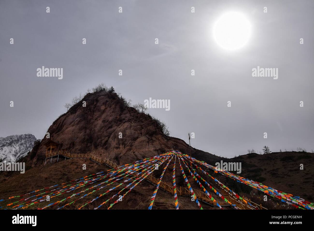 Mati Temple in Gansu province in China and the prayer flags fluttering in the foreground. Stock Photo