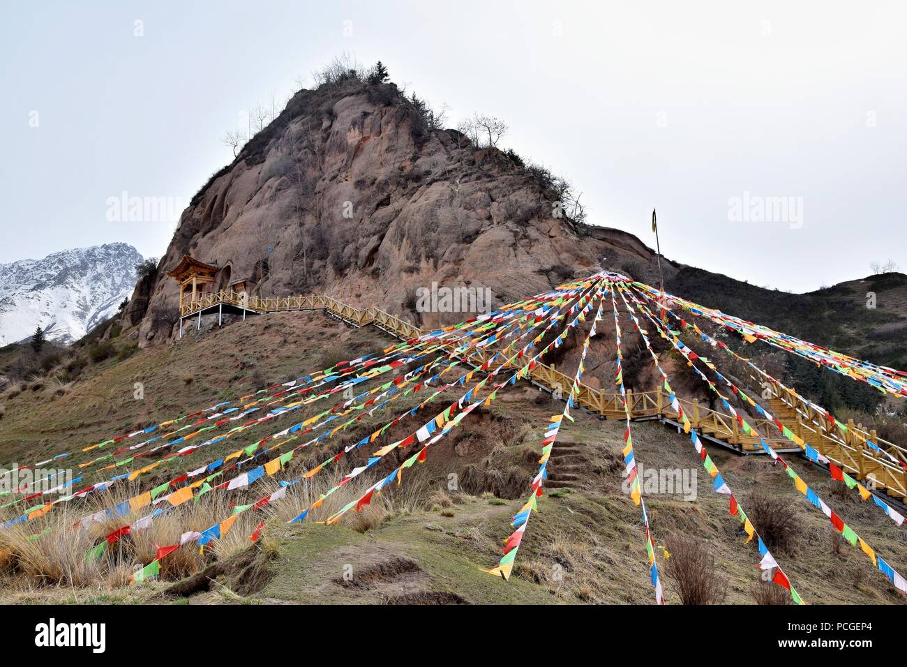 Mati Temple in Gansu province in China and the prayer flags fluttering in the foreground. Stock Photo