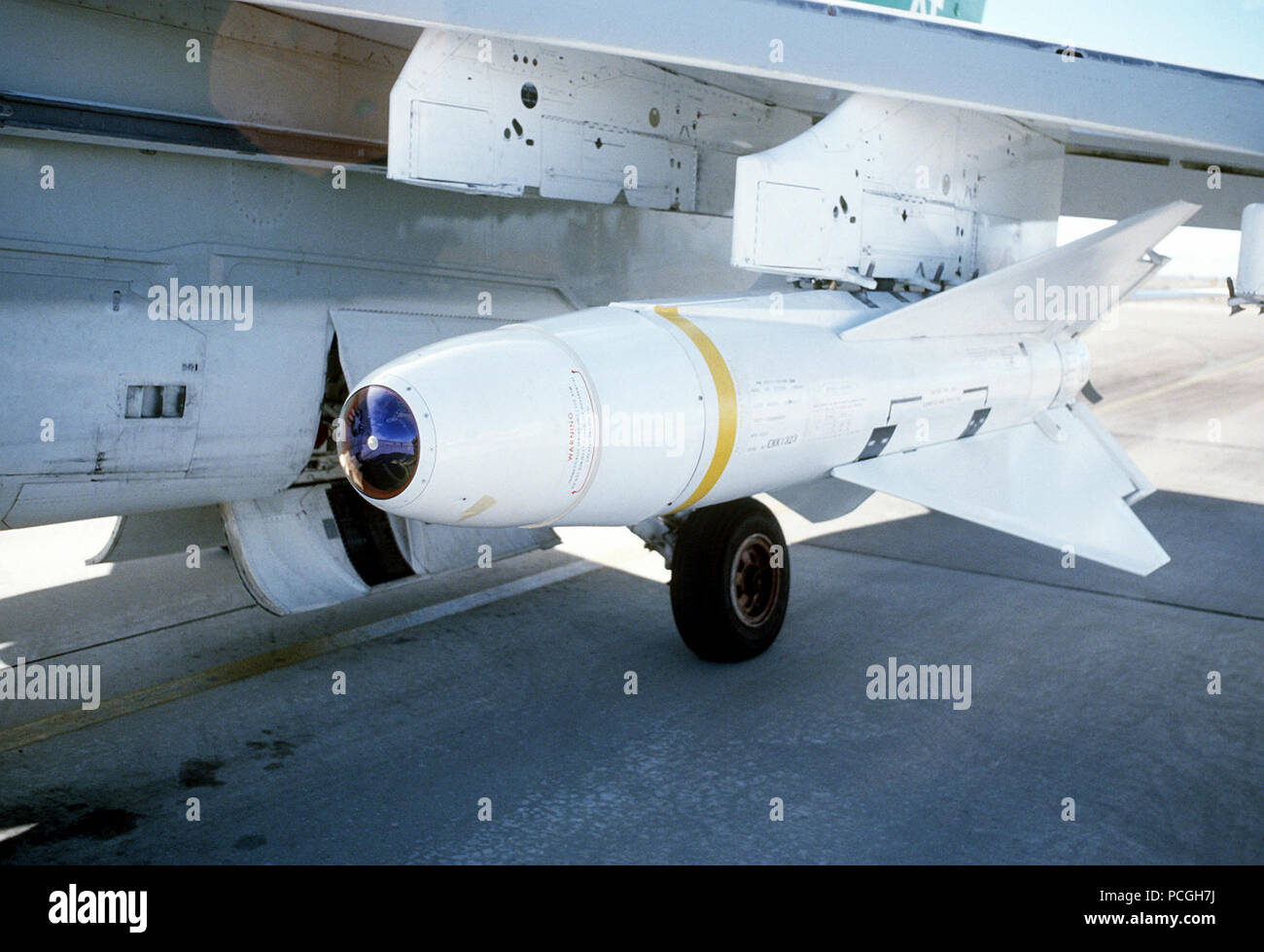 An AGM-62 Walleye glide bomb mounted on the wing pylon of an A-7 Corsair II aircraft at White Sands Missile Range. Stock Photo