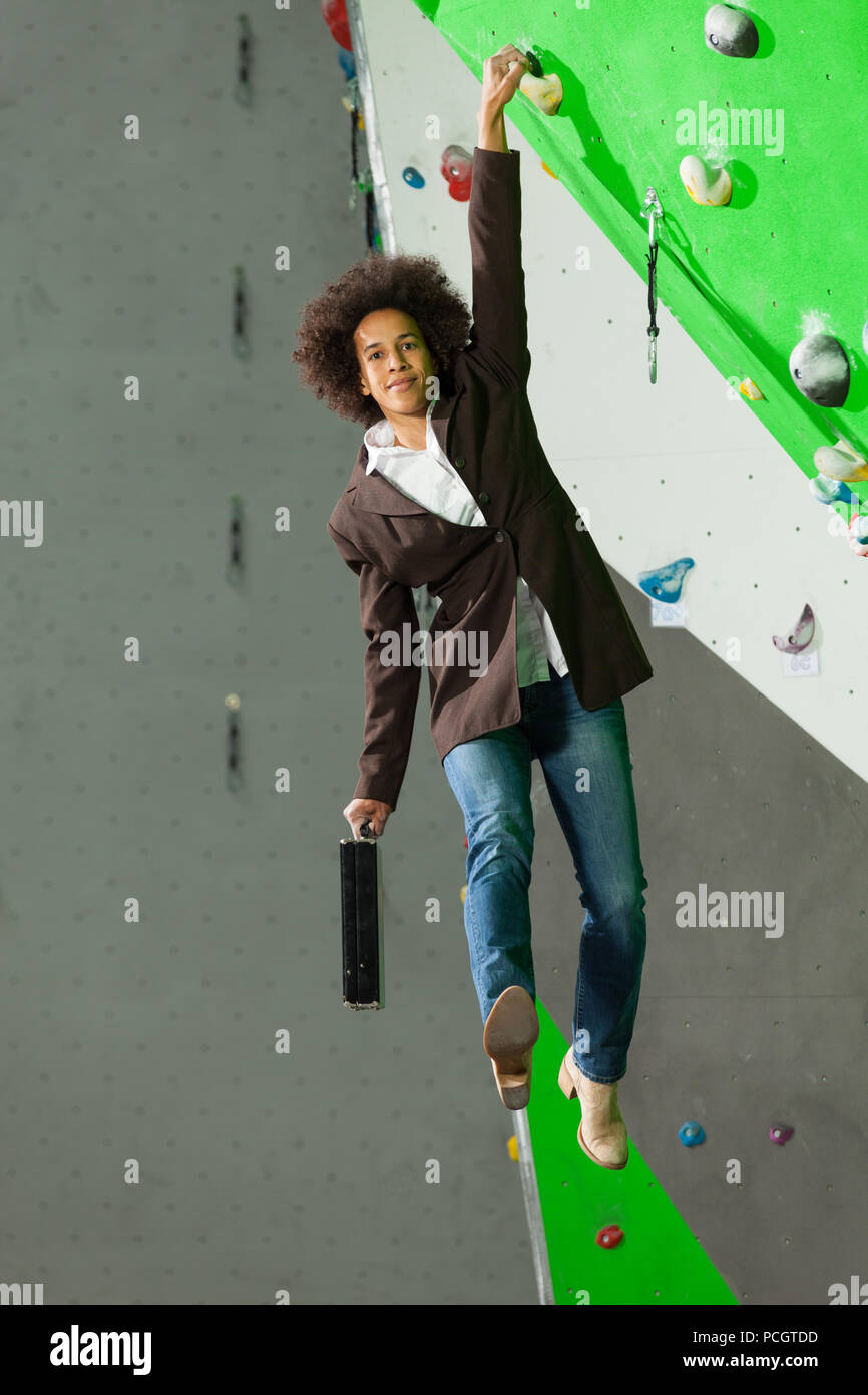 portrait of woman on artificial exercise climbing wall Stock Photo - Alamy