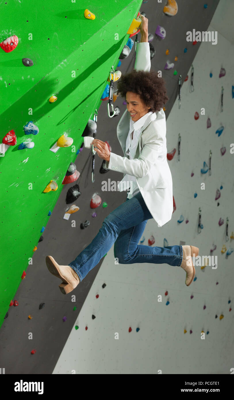 portrait of woman on artificial exercise climbing wall Stock Photo - Alamy