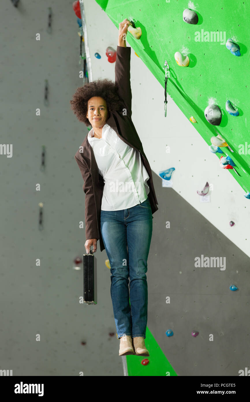 portrait of woman on artificial exercise climbing wall Stock Photo - Alamy