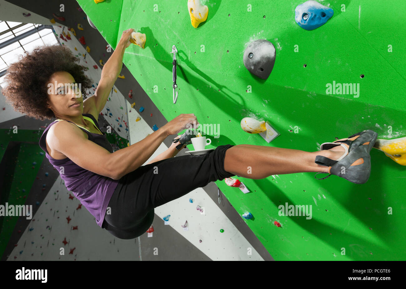 portrait of woman on artificial exercise climbing wall Stock Photo - Alamy