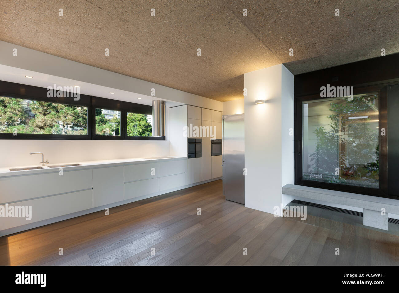 Architecture, modern apartment, domestic kitchen with windows Stock Photo