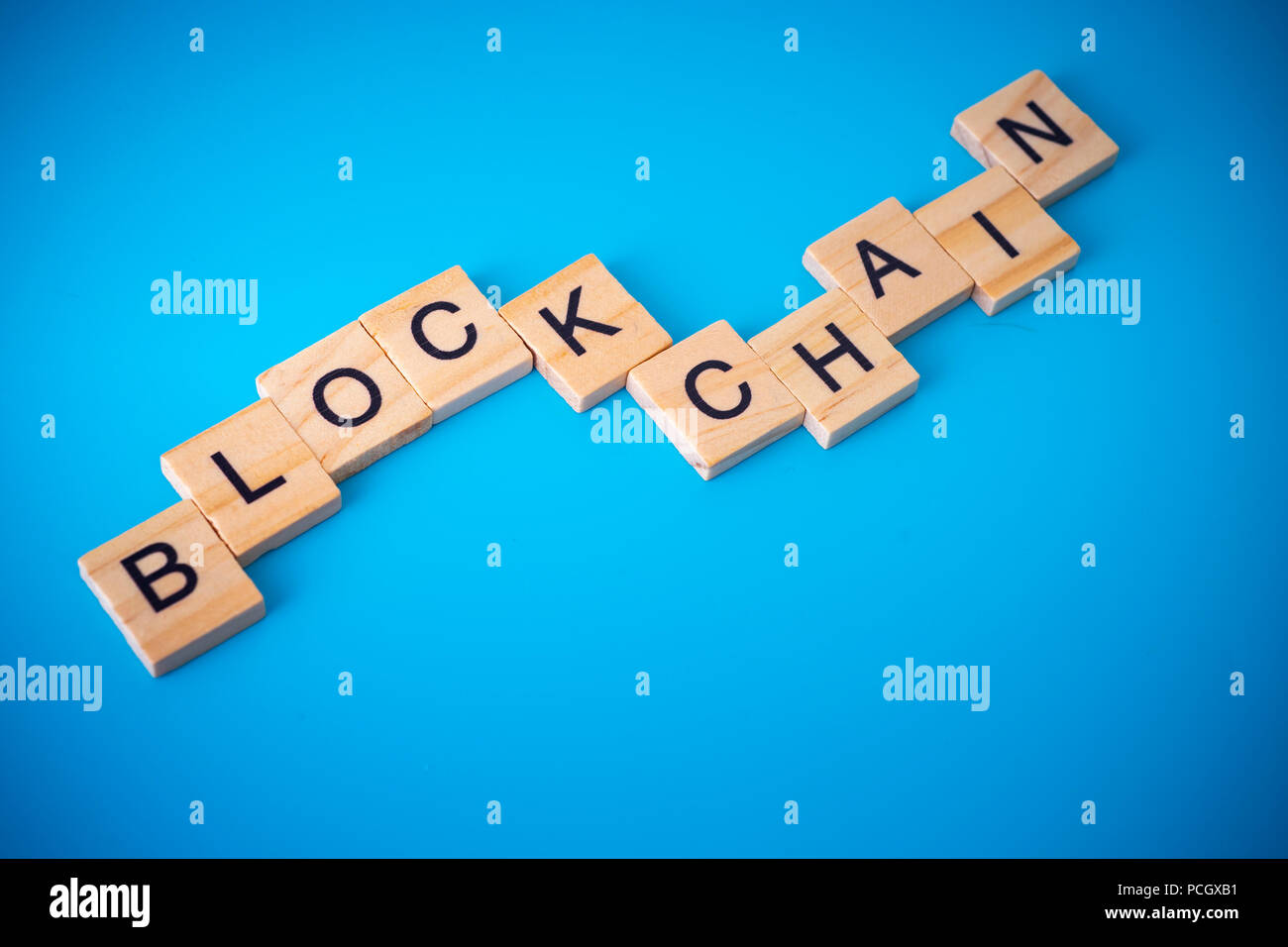 Workers arranging wood with text Blockchain. Stock Photo