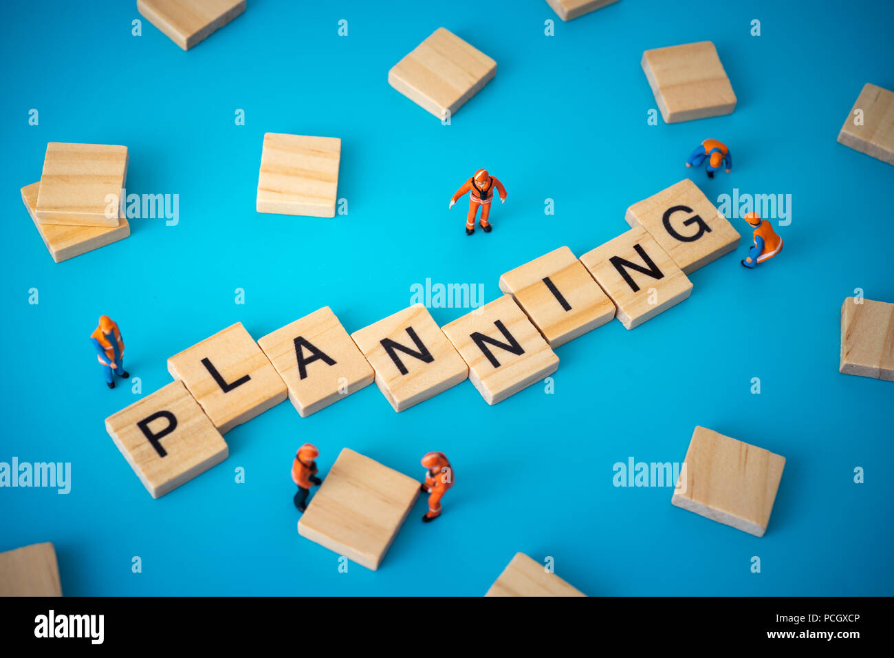 Business concept of planning. Workers arranging wood with text Stock