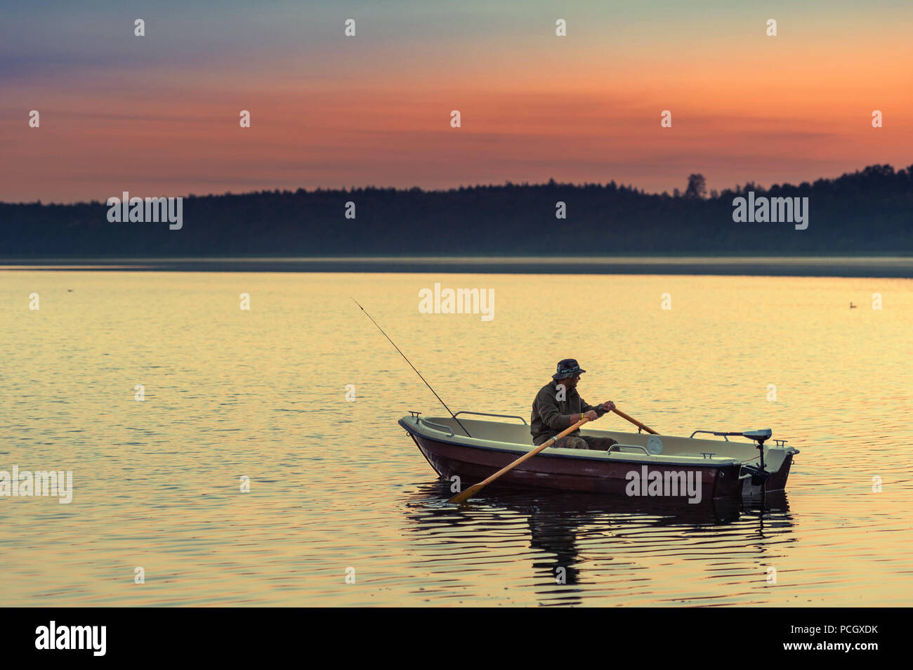 man fishes in the lakes of the Mazury Stock Photo