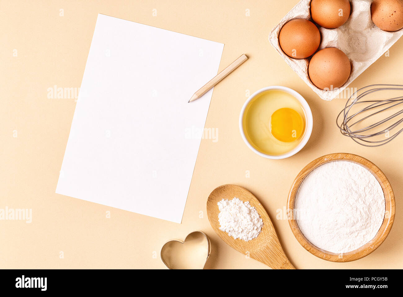 Ingredients and utensils for baking on a pastel background, top view