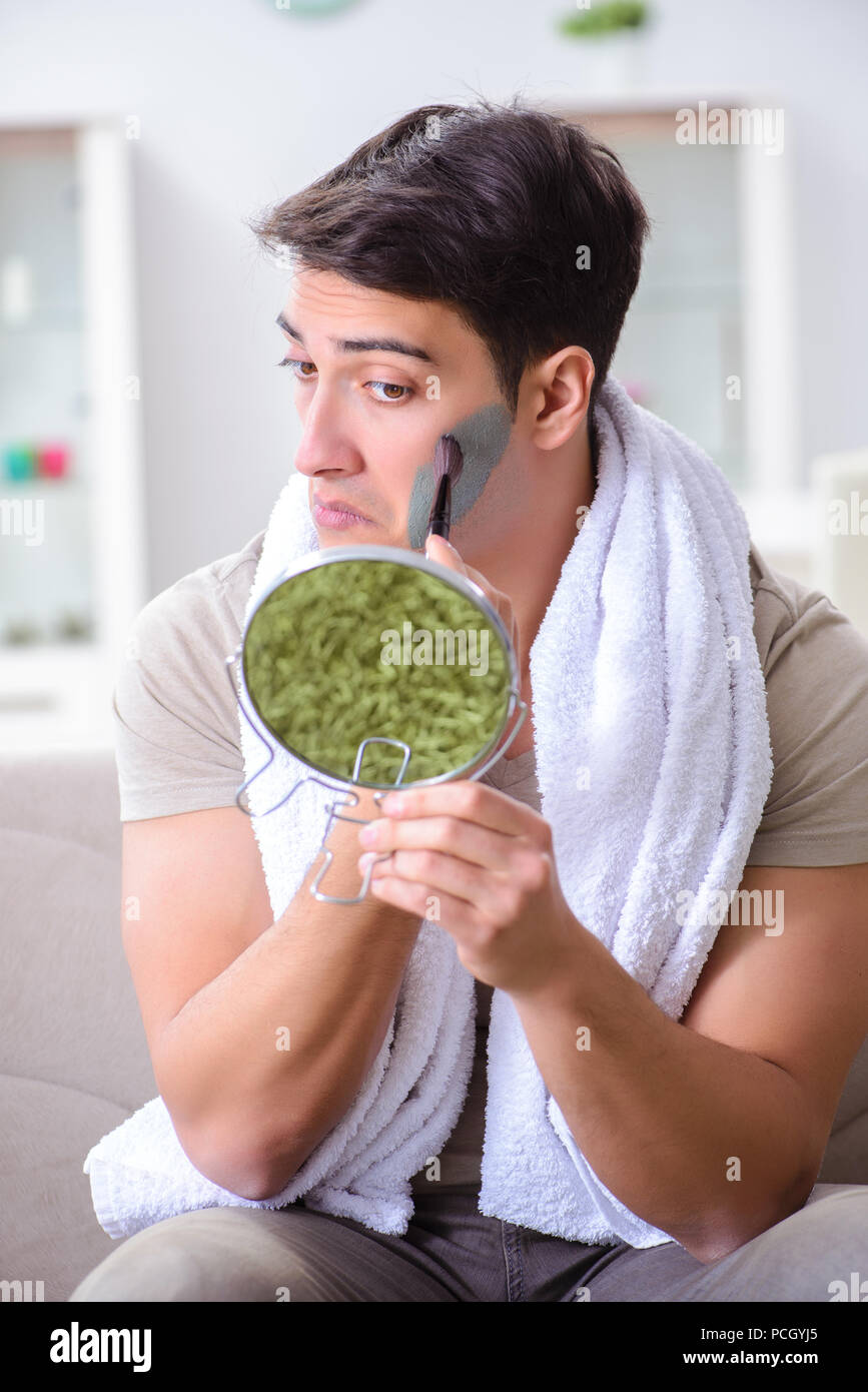 Handsome applying clay mask on face Stock Photo - Alamy